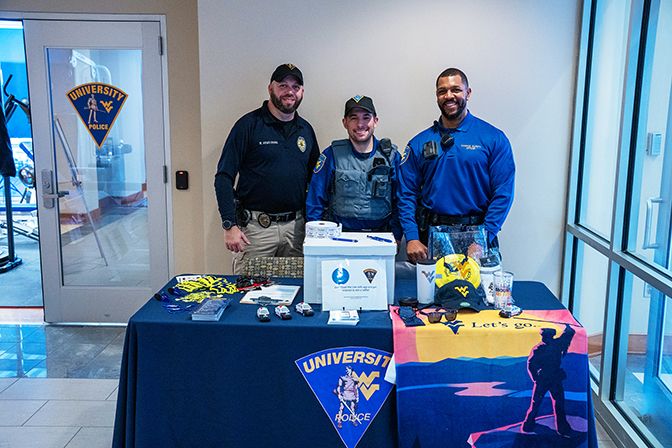 Sgt. Brock Armstrong and Campus Safety Officers Steven Ciuni and Jaron Thomas work a LiveSafe tabling event