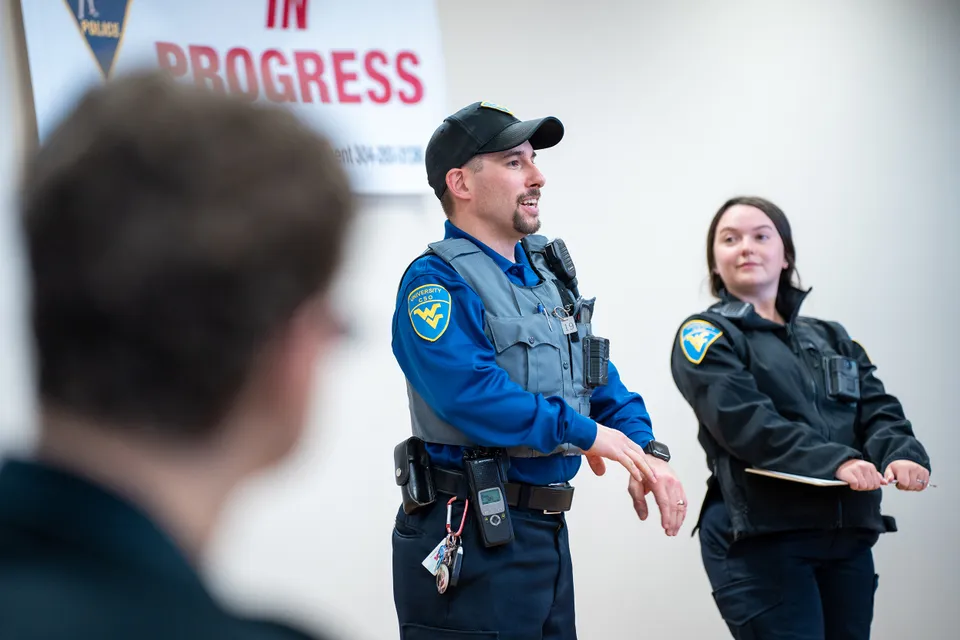 Two Campus Safety Officers speak at a training for Criminology majors